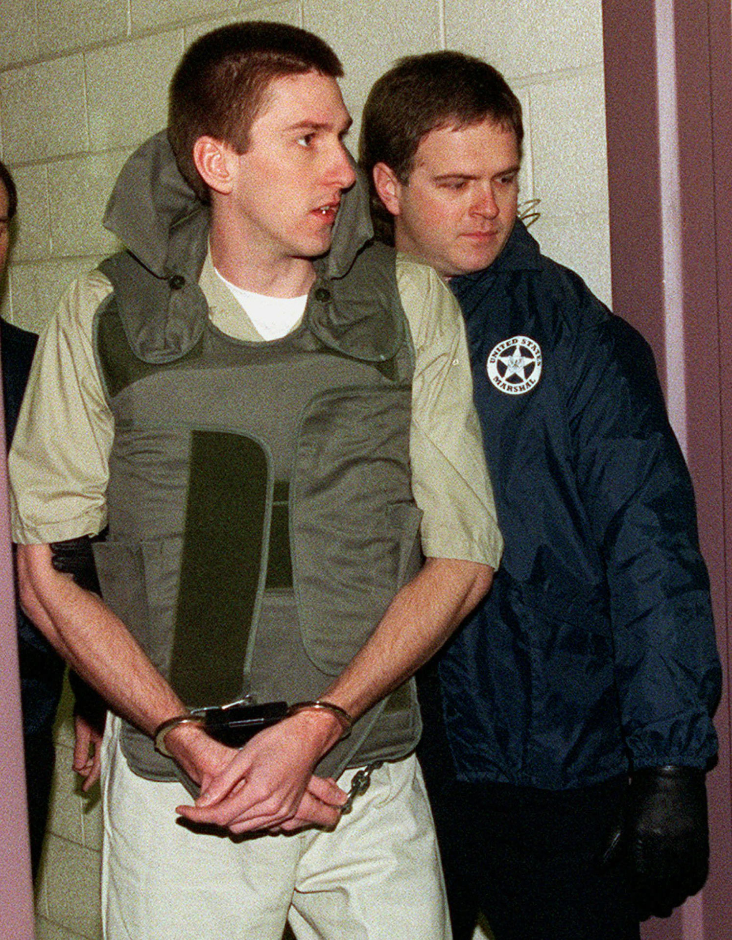 Oklahoma City bombing defendant Timothy McVeigh is escorted by a U.S. Marshall to a change of venue hearing on January 31, 1996. McVeigh was eventually found guilty of the bombing of the Alfred P. Murrah Federal Building, which left 168 people dead and was one of the single worst acts of terrorism in U.S. history. He was executed on June 11, 2001.   