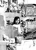 Girl and child amid the ruins of Saigon, Vietnam